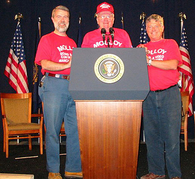 Ed Brouder, Bob Molloy and Bob Surtees at the presidential podium during a presidential visit to NewHampshire